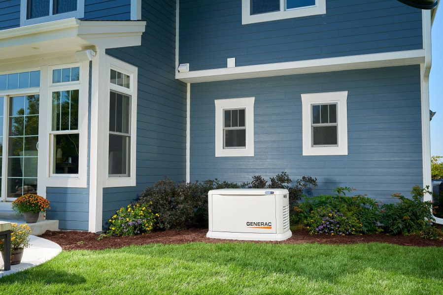 A generac generator in the backyard of a residential home