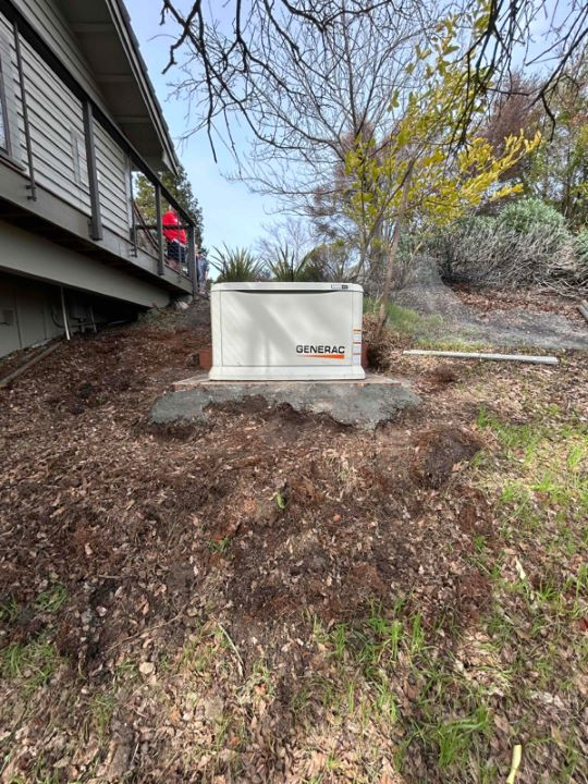 Generac generator installed on the slope of a hill next to a residential customers home