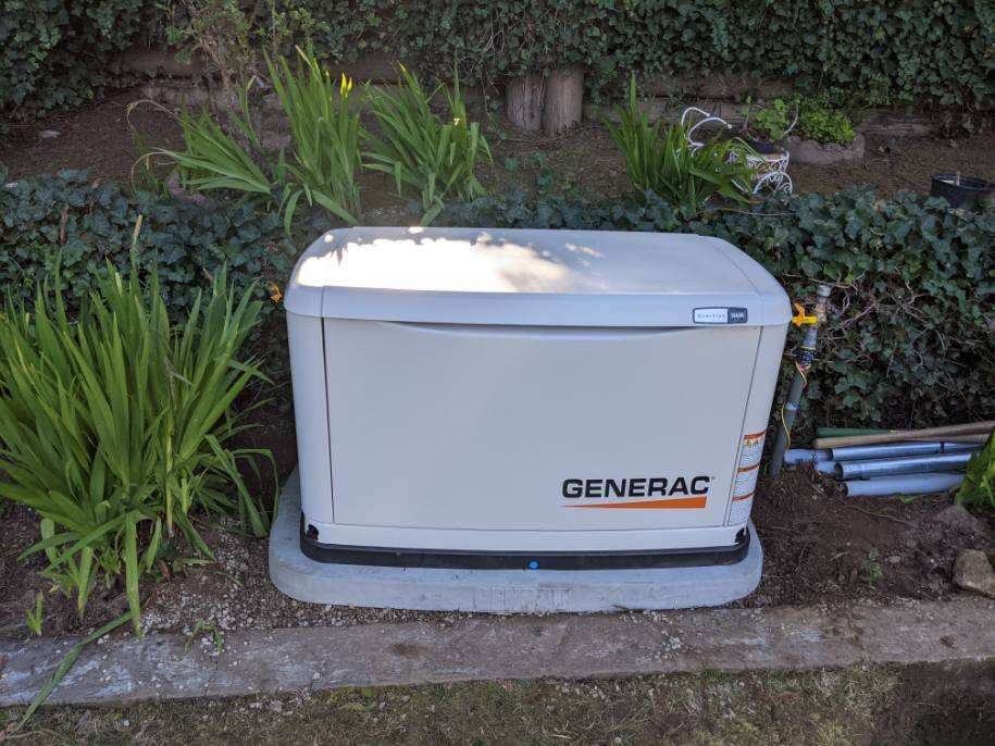 Generac generator installed in the backyard of a residential clients house